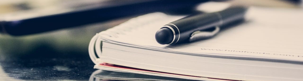A photo of a pen and notebook